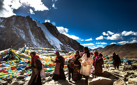 well-dressed Tibetan pilgrims are circling sacred Mount Kailash.