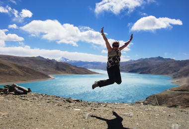 Excited tourist beside Yamdrok Lake