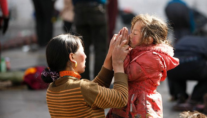 Praying in front of the Jokhang Temple