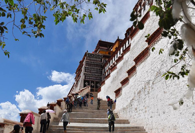 Tourists take photos as they climb Potala Palace