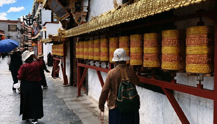 Turning prayer wheels along Barkhor Street