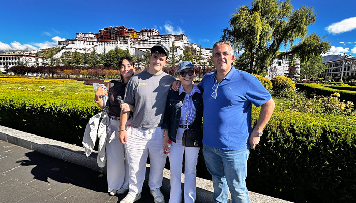Family travelers visiting Potala Palace on a private Tibet tour