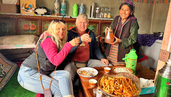Travelers visiting a local Tibetan family during a private Tibet tour