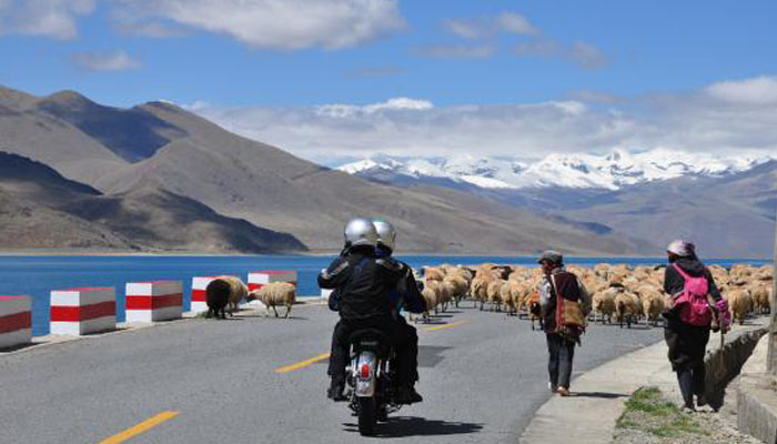 Motobiking via Yamdrok Lake