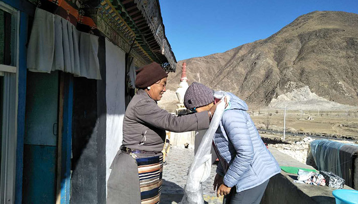 Local Tibetan greets customers