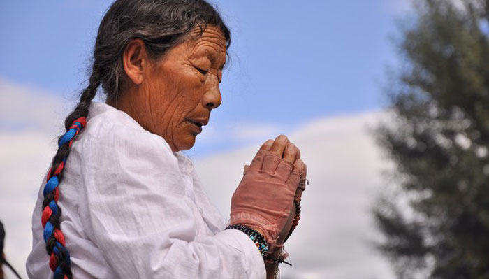 Tibetan Woman in Prayer